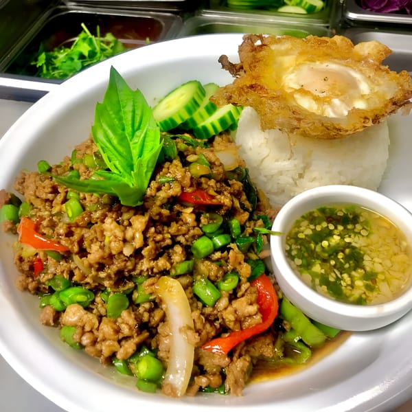 One More Thai's Pad Krapow with minced pork, green beans, red peppers, rice, and a fried egg.