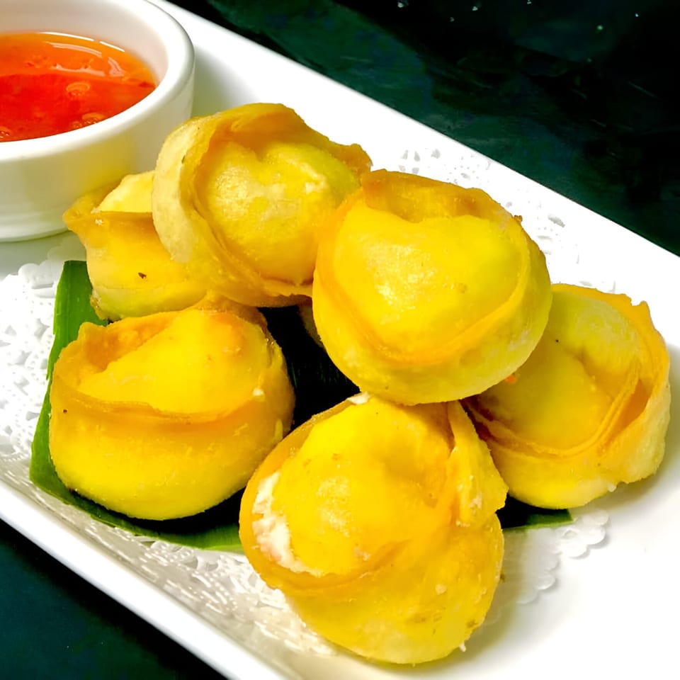 Golden fried wontons, filled with cream cheese, served with a side of sweet chili sauce.